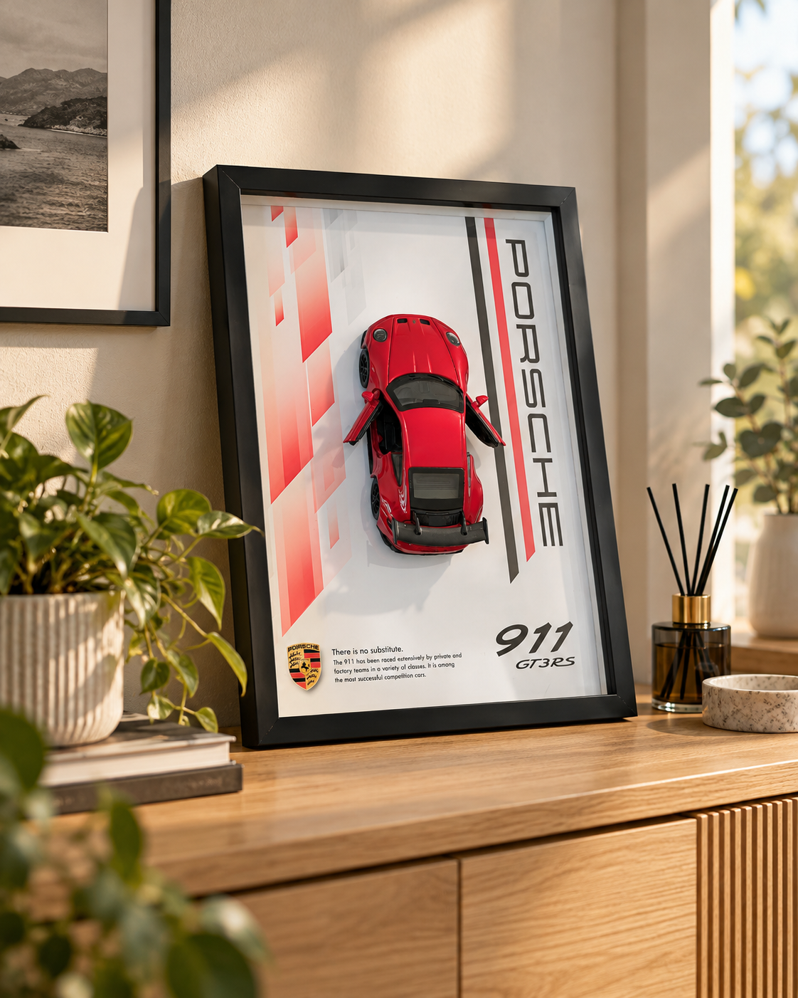 Red 1:32 Porsche 911 GT3 RS diecast car in a black A4 shadow box frame on a wooden sideboard