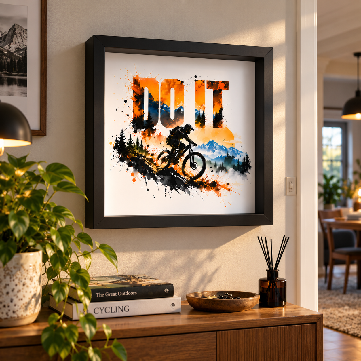 DO IT mountain bike print in a black 25 x 25 cm shadow box frame on a wall above a sideboard (mock-up)